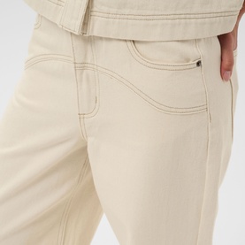 Model wearing Kaffe Off White Washed trousers, close-up showing contrast stitching detail on front pockets and waistband.