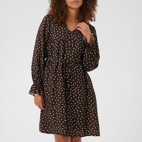 Model wearing dark brown polka dot mini dress with V-neckline, long sleeves, and tie waist belt