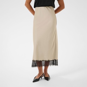 Model wearing Kaffe Feather Gray midi slip skirt with black lace hem trim, styled with black slingback heels and black top.