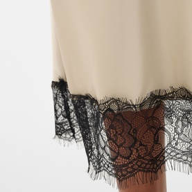 Kaffe womenswear dress in Feather Gray with black floral lace trim hem detail, close-up view.