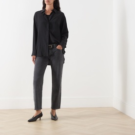 Model wearing Rag & Bone Straight Jeans in angela, styled with a black oversized shirt, belt, and black kitten heel mules.