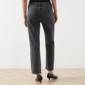 Model wearing Rag & Bone Straight Jeans in angela grey, rear view showing relaxed fit, cropped hem and back pockets, styled with black kitten heels.