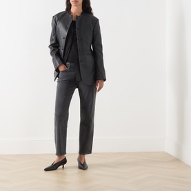 Model wearing Rag & Bone Straight Jeans in angela dark grey denim, styled with a collarless blazer and black kitten heels.