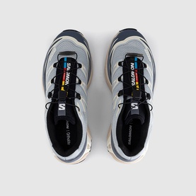 Salomon trainers in Pearl Blue Grisaille, overhead view showing lace-up design, black tongue branding, and light cream midsole.