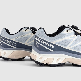 Salomon trainers in Pearl Blue Grisaille colourway, rear three-quarter view showing chunky black lugged sole and heel branding.