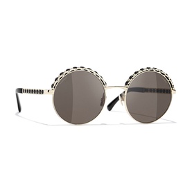 Chanel round sunglasses in gold-tone metal with black chain-link trim detail on frames and brown mirror lenses