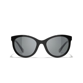 Black oval-frame sunglasses with dark grey lenses and slim temples, front-facing view