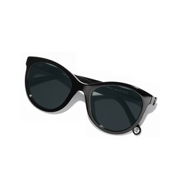 Black oversized round cat-eye sunglasses with dark lenses, silver-tone frame detailing and small embellished temple tip