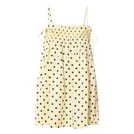 Damson Madder Butter Spot dress in yellow cotton with dark polka dots, shirred bust, tie shoulders, and a loose A-line silhouette