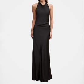 Model wearing black halterneck sleeveless maxi dress with ruched waist detail and flowing skirt