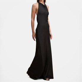 Model wearing black halterneck sleeveless maxi dress with open back and flared hem skirt
