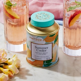 Fortnum & Mason Summer Cooler 20 Silky Tea Bag Tin, floral gold and teal lidded tin styled with iced pink drinks and peach slices