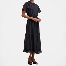 Model wearing black midi dress with flutter sleeves, drawstring waist, tiered skirt and lace hem trim, styled with black mules