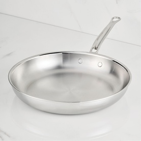 Hestan ProBond Luxe Skillet 32cm in polished stainless steel with seamless handle, shown on marble surface.