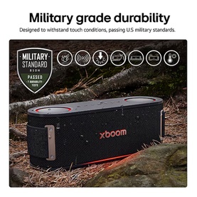 Libby xboom Bounce by will.i.am Bluetooth Speaker in black, shown outdoors on rocks with military grade durability badge