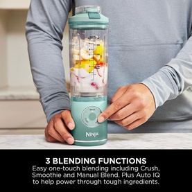 Ninja Blast Max Cordless Portable Blender in Seaglass, held by model, filled with fruit, highlighting 3 blending functions