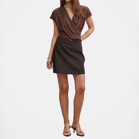 Model wearing dark brown wrap-top mini dress with belt detail, styled with strappy heeled sandals
