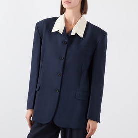 Model wearing navy blazer with contrast cream collar, button front, and matching navy trousers