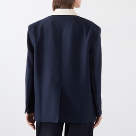 Model wearing navy blazer with contrast cream collar, styled with navy trousers, rear view