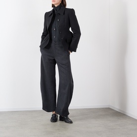Model wearing Source Unknown black wool-blend blazer with wide-leg trousers, bow-neck shirt and black loafers