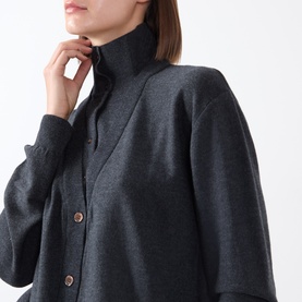 Model wearing Source Unknown Fabbie Layered Cardigan in charcoal with turtleneck, dropped shoulders, and copper front button fastening