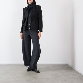 Model wearing Source Unknown Fabbie Layered Cardigan in charcoal, styled with black wide-leg trousers and black loafers.