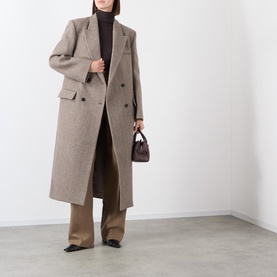 Model wearing Source Unknown Reyna Double-Breasted Coat in beige wool, styled with brown turtleneck, wide-leg trousers, and carrying a dark mini bag
