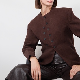 Model wearing Source Unknown Banton Double-Breasted Jacket in brown, collarless with structured shoulders, styled with dark leather trousers.
