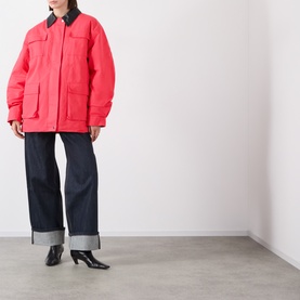 Model wearing Source Unknown Baia Fleece Field Jacket in red with contrast dark collar, four front pockets, styled with dark wide-leg jeans and black