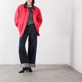 Model wearing Source Unknown Baia Fleece Field Jacket in red with contrast collar, styled with dark wide-leg jeans and black heeled boots.