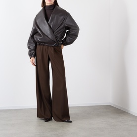 Model wearing Source Unknown Eleni Faux Leather Jacket in brown, shawl collar wrap style, styled with wide-leg brown trousers and black heels