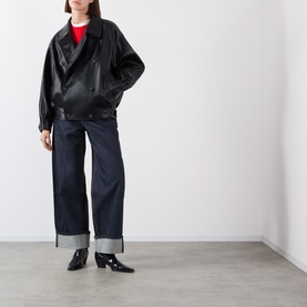 Model wearing Source Unknown Viellino Faux Leather Jacket in black, double-breasted with shirt collar, styled with dark wide-leg jeans and black