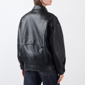 Model wearing Source Unknown Viellino Faux Leather Jacket in black, rear view, showing dropped shoulders and straight hem, styled with blue jeans.