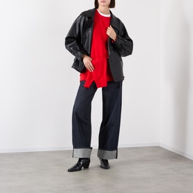 Model wearing Source Unknown Viellino Faux Leather Jacket in black with red knit top and dark wide-leg cuffed jeans, styled with black ankle boots