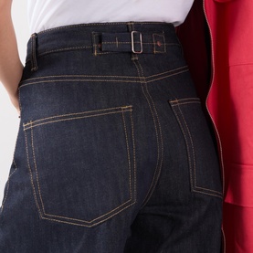 Model wearing Piero Wide Leg Jeans in dark blue wash with tobacco stitching, belt detail, and five-pocket styling at back.