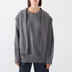 Model wearing Source Unknown Tio Shawl Sweater in charcoal, featuring layered shawl detail, dropped shoulders and ribbed trims, styled with dark