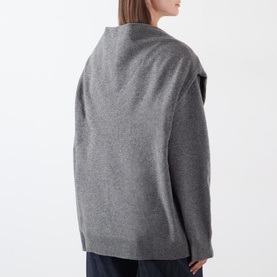 Model wearing Source Unknown Tio Shawl Sweater in charcoal, showing back view of relaxed knit with layered shawl detail and dropped shoulders.