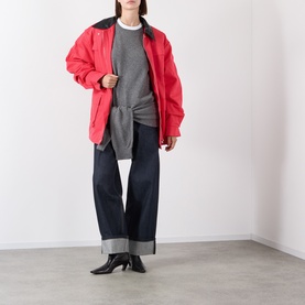 Model wearing Source Unknown Tio Shawl Sweater in charcoal with red oversized jacket, dark wide-leg jeans and black heeled boots.