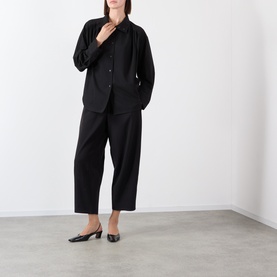 Model wearing black relaxed blazer and wide-leg cropped trousers, styled with black square-toe kitten heel mules