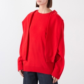 Model wearing Source Unknown Tio Shawl Sweater in red, featuring layered shawl design, dropped shoulders, and ribbed trims, styled with dark jeans.