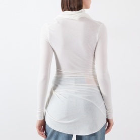 Model wearing Source Unknown Folgore Draped Top in ivory, semi-sheer with ruched detailing and curved hem, back view
