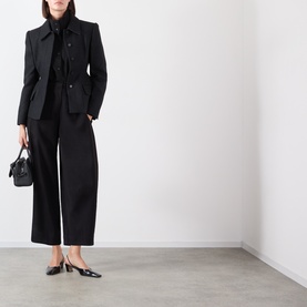 Model wearing Bimba Pintuck Trousers in black, wide-leg cropped style with pintuck detail, styled with black blazer and heels.
