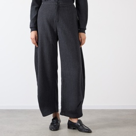 Model wearing Source Unknown Ebbe Balloon Trousers in charcoal, wide balloon-leg silhouette with clean hems, styled with black loafers.