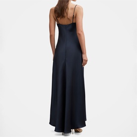 Model wearing navy satin maxi slip dress with thin shoulder straps, cowl back neckline, and flared hem, shown from behind