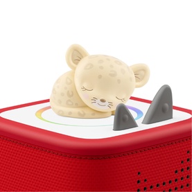 Tonies cream leopard character figure resting on top of a red Toniebox speaker with rainbow light ring visible