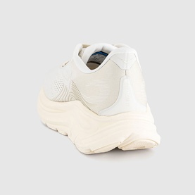 Hoka trainer in Alabaster Oat Milk, chunky cream sole, mixed mesh and smooth upper panels, rear three-quarter view