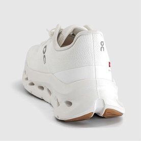 On Running trainer in white ivory, rear three-quarter view showing chunky cloud sole with tan rubber outsole and logo tab detail.