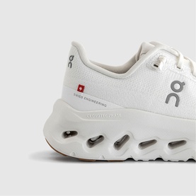 On Running trainer in white ivory, mesh upper, Swiss Engineering branding, chunky white cloud sole with tan base detail
