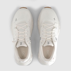 On Running trainers in white ivory, top-down view showing laces, mesh upper and gum-tone sole detail, pair laid flat