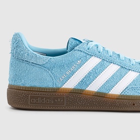 Adidas Handball Spezial Care Bears Bliss Blue suede trainers with white stripes, Care Bears branding, and gum rubber sole.